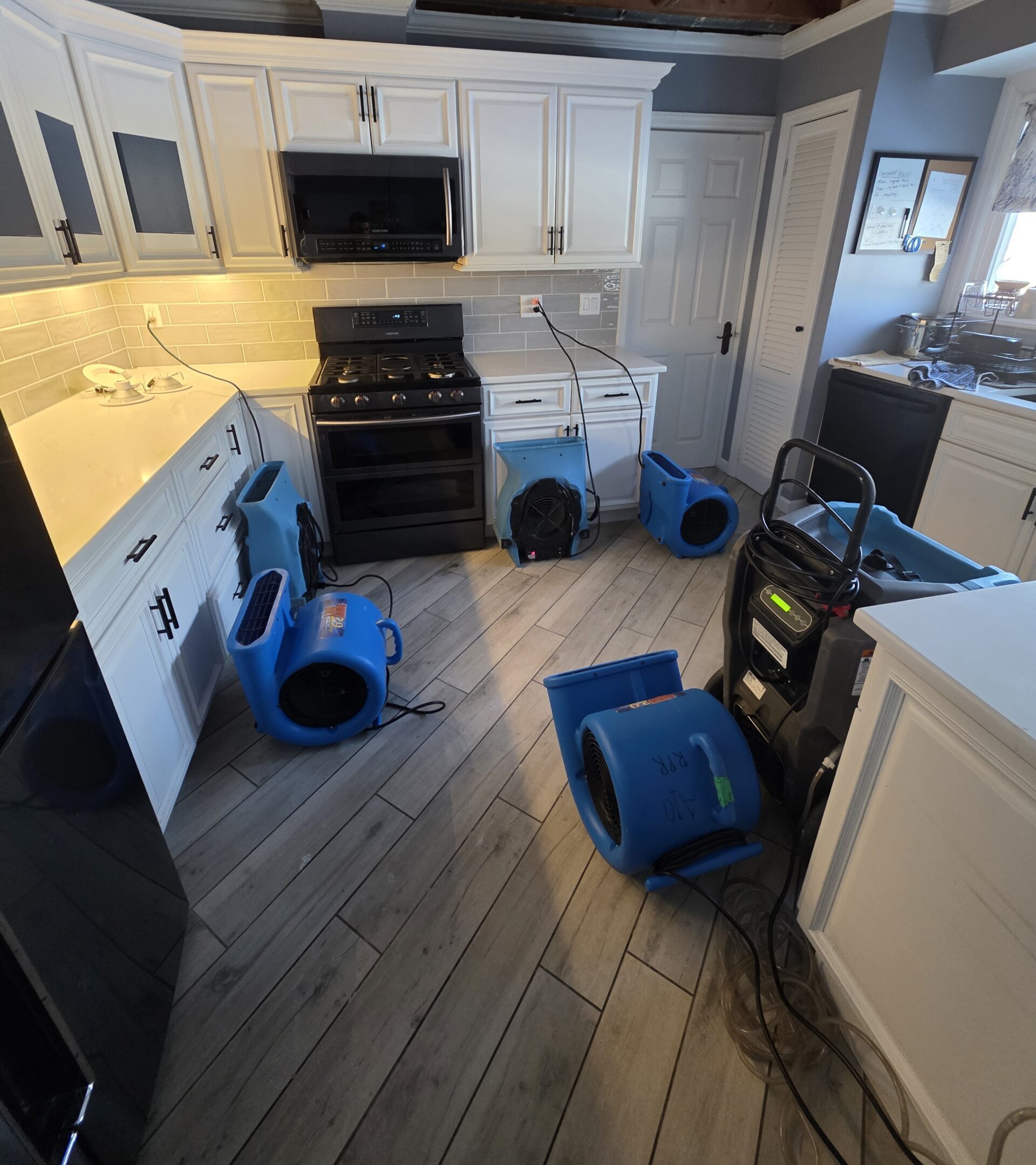 Property damage restoration in NJ: air movers and a dehumidifier drying a water-damaged home