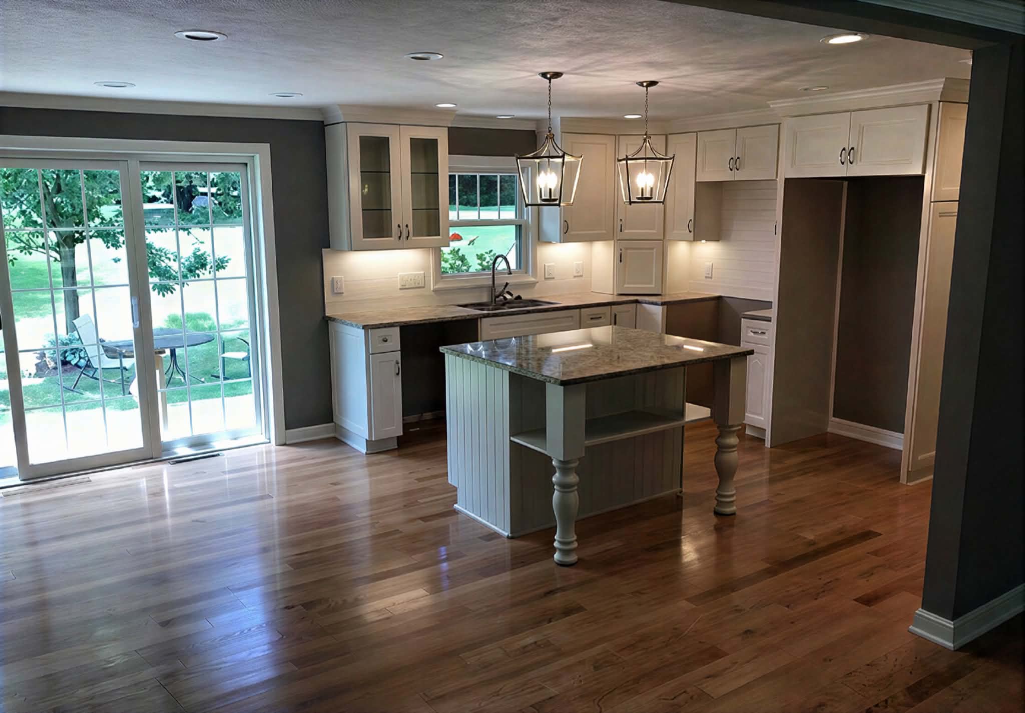 Reconstruction services in NJ: restored kitchen with new hardwood flooring after water damage repairs